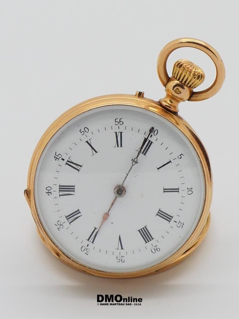 Gold pocket watch with white dial and Roman numerals, lying on its side on a pale surface.