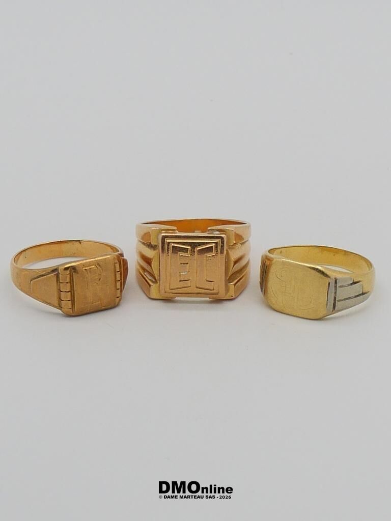 Three gold signet rings with square engraved faces on a white background.